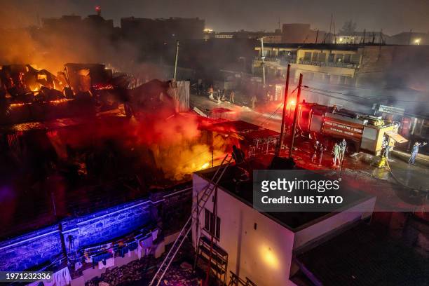 Firemen fight a blaze following a series of explosions in the Embakasi area of Nairobi, Kenya on February 2, 2024. At least 30 people have been...