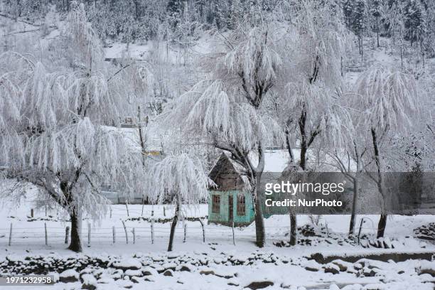Snow-covered residential house is seen after heavy snowfall in the Kangan area of the Ganderbal district, 60 kilometers from Srinagar city, in Indian...