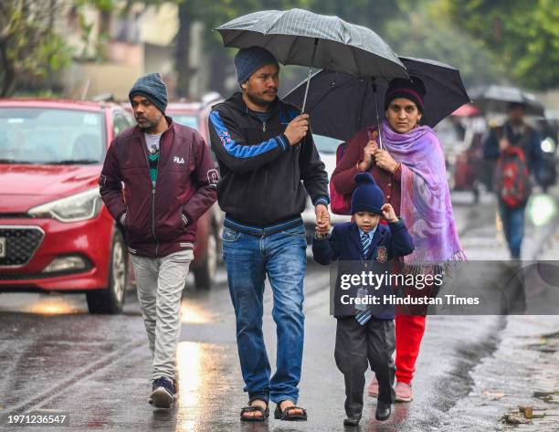 Commuters during light rain in winter, rain increased the severe cold in North India, on February 1, 2024 in Noida, India.