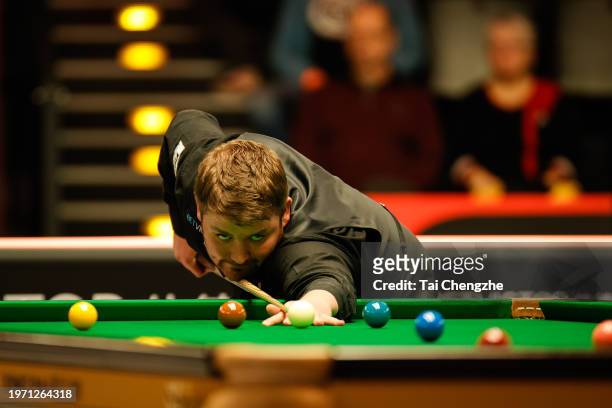 Michael White of Wales plays a shot in the first round match against Ali Carter of England on day one of 2024 BetVictor German Masters at Tempodrom...