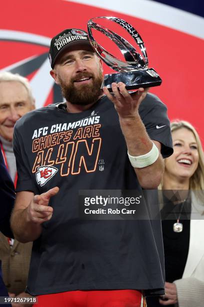 Travis Kelce of the Kansas City Chiefs celebrates with the Lamar Hunt Trophy after a 17-10 victory against the Baltimore Ravens in the AFC...