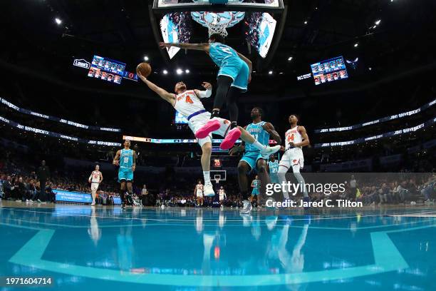 Duane Washington Jr. #4 of the New York Knicks attempts a lay up against James Bouknight of the Charlotte Hornets during the second half of the game...