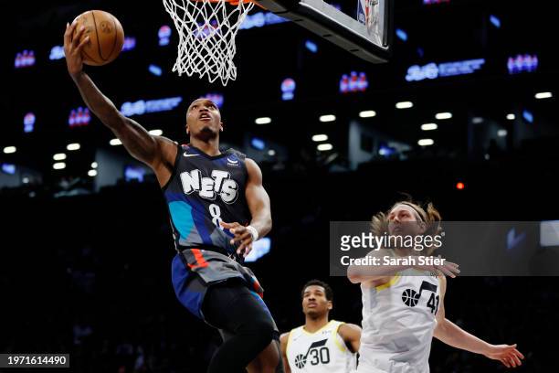 Lonnie Walker IV of the Brooklyn Nets goes to the basket as Kelly Olynyk of the Utah Jazz defends during the second half at Barclays Center on...