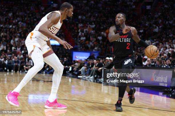 Terry Rozier of the Miami Heat drives against Kevin Durant of the Phoenix Suns during the third quarter of the game at Kaseya Center on January 29,...