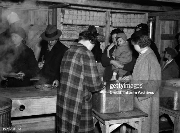 Refugees get food while on line at Tent City near Shawneetown, Illinois, January 1937. Tent City was created in response to assist refugees from the...