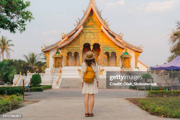 woman exploring buddhist temple in laos - laos stock pictures, royalty-free photos & images