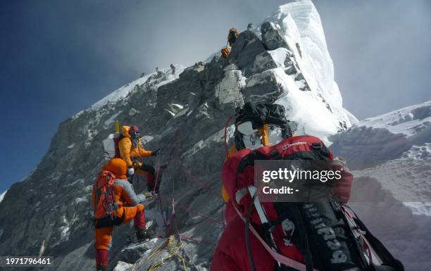 Nepal-Everest-environment-climbing, FOCUS by Deepesh Shrestha In this May 19, 2009 file photograph, unidentified mountaineers walk past the Hillary...