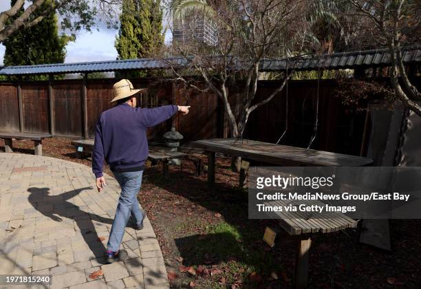Gary Tom, a 23-year volunteer and the current garden curator, shows where bonsai trees were stolen when thieves breached a fence at the Bonsai Garden...