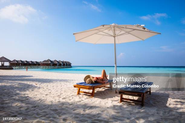 woman relaxing on lounge chair, maldives - ari atoll stock pictures, royalty-free photos & images