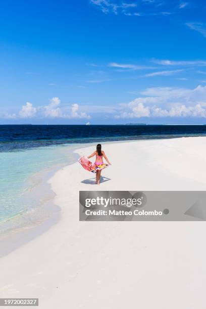 woman with sarong walking on a beach, maldives - ari atoll stock pictures, royalty-free photos & images