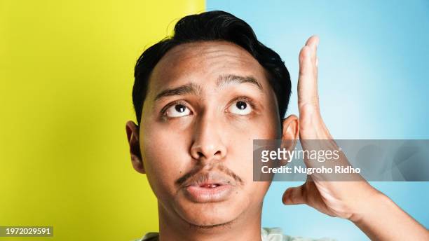 man slap his own face with hand close up - slapping face stock pictures, royalty-free photos & images