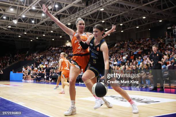 Jade Melbourne of the Capitals is challenged by Cassandra Brown of the Fire during the WNBL match between UC Capitals and Townsville Fire at National...