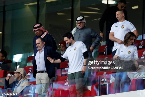 Jordan's Crown Prince Hussein greets people during the Qatar 2023 AFC Asian Cup quarter-final football match between Tajikistan and Jordan at the...
