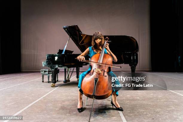 child girl playing cello at stage theater - cuban people stock pictures, royalty-free photos & images