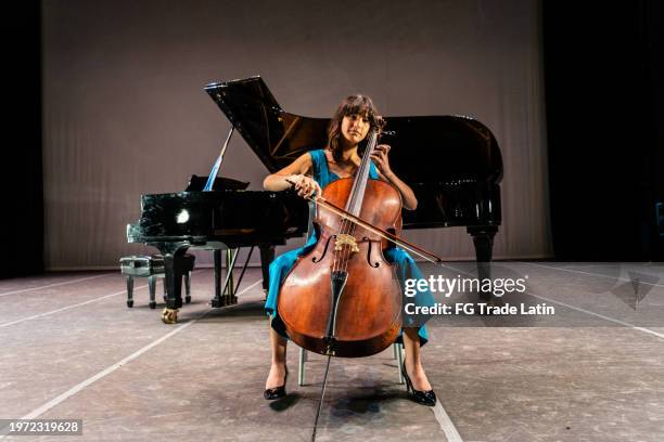 child girl playing cello at stage theater - space opera stock pictures, royalty-free photos & images