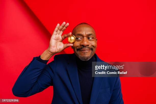 Comedian and Actor Sir Lenny Henry supports Red Nose Day 2024 by holding a new Red Nose. Plastic free, recyclable and plant-based on December 6, 2023...