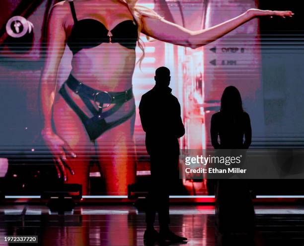 Jason Luv and Abella Danger are silhouetted onstage as they present an award during the 2024 Adult Video News Awards at Resorts World Las Vegas on...