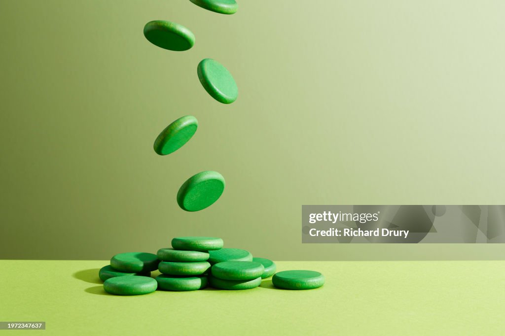 Coins falling into a heap on a tabletop