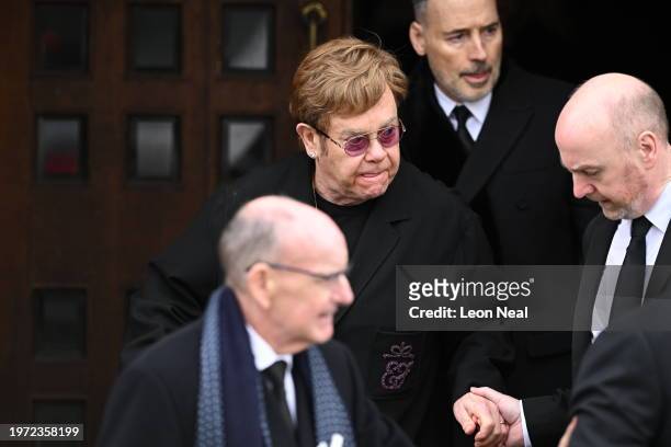 Elton John and David Furnish depart after the funeral mass of Derek Draper at St Mary the Virgin Church, on February 2, 2024 in London, England.