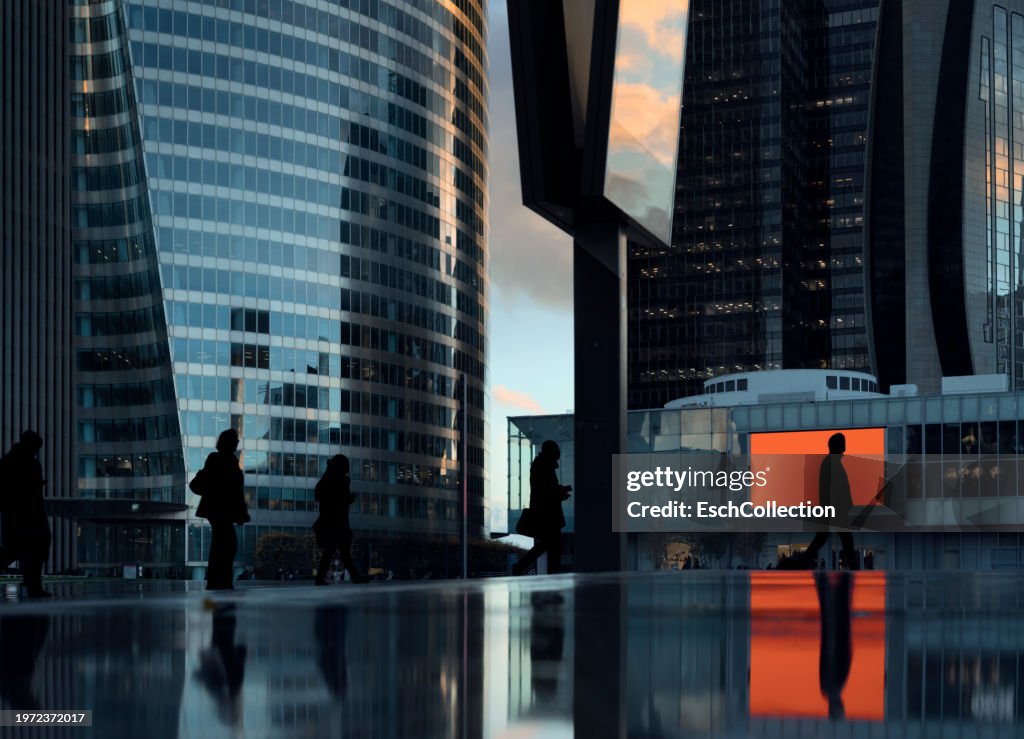 Afternoon commute with people passing by at pedestrian zone of modern business district