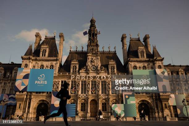 Man running next to the Hôtel de Ville on January 22, 2024 in Paris, France. The city is gearing up to host the XXXIII Olympic Summer Games, from 26...