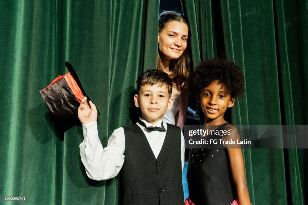 Portrait of children doing a presentation on the stage theater