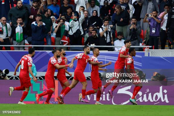 Jordan's defender Abdallah Nasib celebrates scoring his team's first goal during the Qatar 2023 AFC Asian Cup quarter-final football match between...
