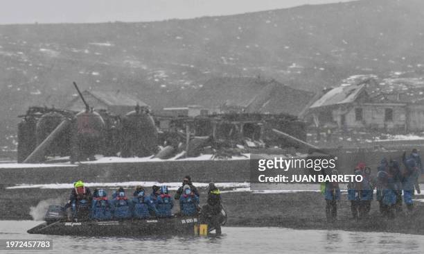 Tourists visit the remains of the Hector Whaling Company at Whaler's Bay in Deception Island, in the western Antarctica peninsula on January 24,...