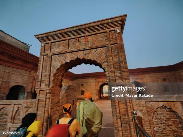 tourists entering the golden temple with a local guide - indian tour guide stock pictures, royalty-free photos & images