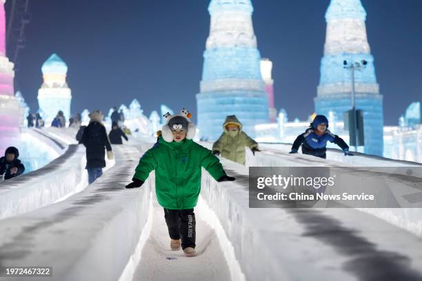 Tourists visit the Harbin Ice and Snow World, one of the world's leading theme parks featuring large-scale ice and snow sculptures, on January 26,...