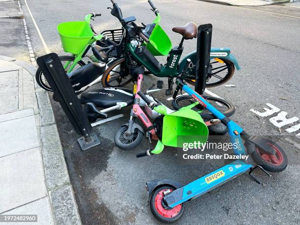 Fitzrovia, LONDON,ENGLAND - January 26th 2024 : Electric mixed bikes and E-Scooter on a street in London, England.