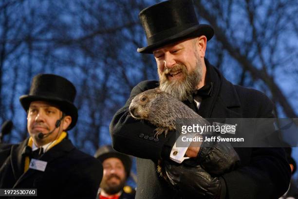 Groundhog handler AJ Dereume holds Punxsutawney Phil after he did not see his shadow predicting an early Spring during the 138th annual Groundhog Day...