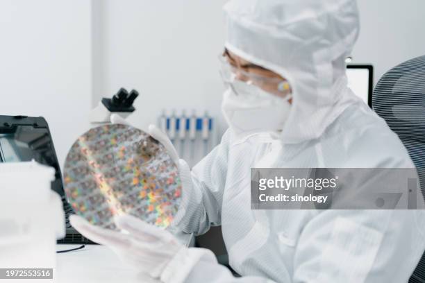 chip engineers are inspecting wafer chips in factory - süßgebäck teilchen stock-fotos und bilder