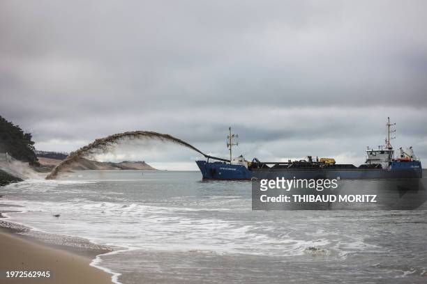 This photo, taken on February 2 shows the dredger ship "Cotes de Bretagne" unloading sand on a beach at Pyla-sur-Mer as part of the re-silting of the...