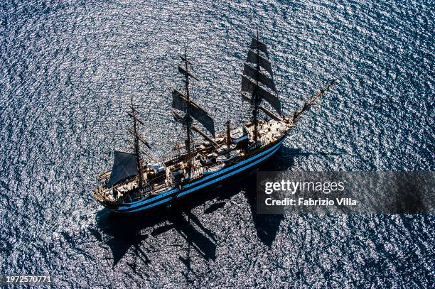 Backlit aerial view of the Italian Navy's historic sailing ship Amerigo Vespucci sailing from the port of La Spezia. The ship is considered the most...