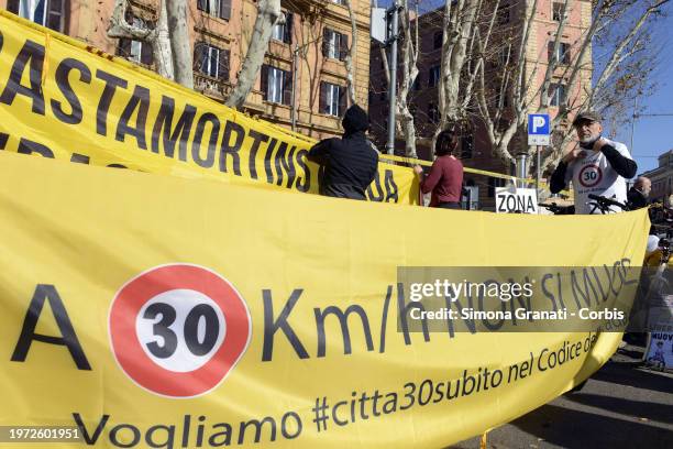 People with banners and placards protest for a new highway code that introduces the ban on exceeding 30 km per hour in the city, on February 2, 2024...