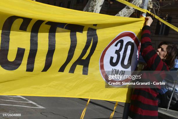 People with banners and placards protest for a new highway code that introduces the ban on exceeding 30 km per hour in the city, on February 2, 2024...