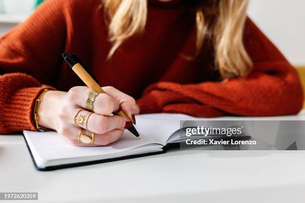 woman taking notes at home - nuria stock pictures, royalty-free photos & images