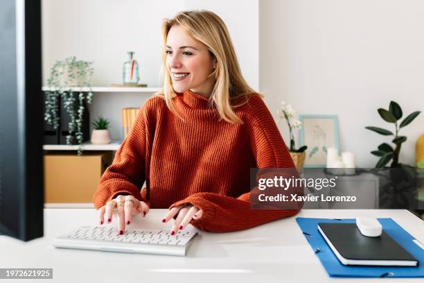 happy young beautiful woman working on laptop at home office. - nuria stock pictures, royalty-free photos & images