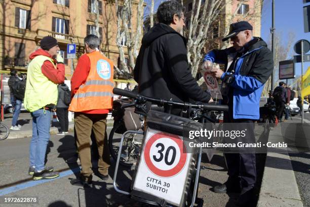 People with banners and placards protest for a new highway code that introduces the ban on exceeding 30 km per hour in the city, on February 2, 2024...