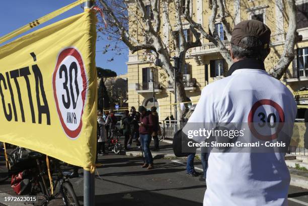 People with banners and placards protest for a new highway code that introduces the ban on exceeding 30 km per hour in the city, on February 2, 2024...