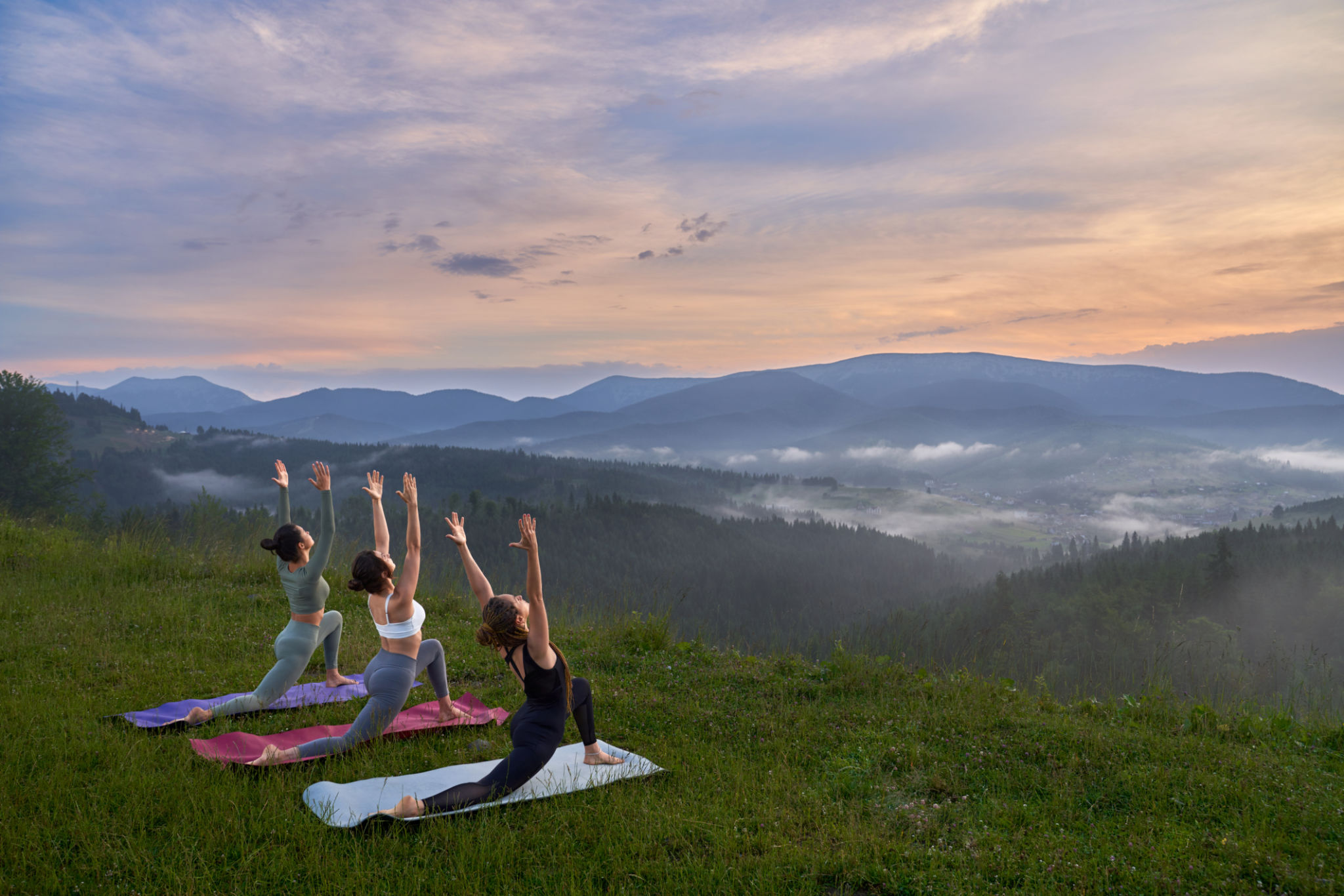 Fitness women doing yoga exercises among nature Fitness women doing yoga exercises among nature