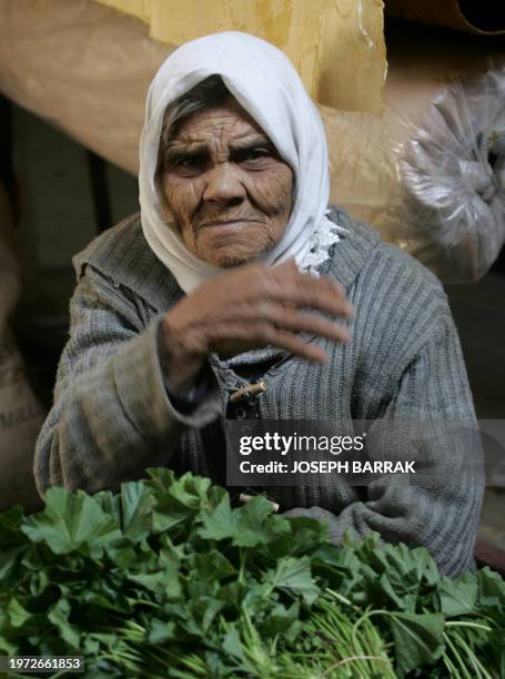 Palestinian elderly woman sells vegetables in the Palestinian refugee camp of Ain el-Helweh in the Lebanese southern port city of Sidon, 19 January...