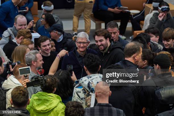 Tim Cook, chief executive officer of Apple Inc., center, at the company's Fifth Avenue store in New York, US, on Friday, Feb. 2, 2024. Apple Inc.'s...