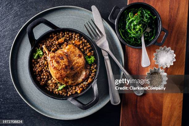 duck confit with puy lentils and spinach - green lentil stock pictures, royalty-free photos & images