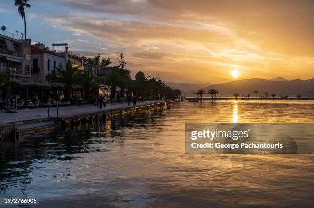 sunset colors in napflio, greece waterfront - mediterranean culture stock pictures, royalty-free photos & images
