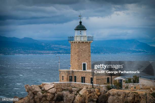 lighthouse on a cloudy day - corinth stock pictures, royalty-free photos & images
