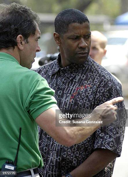 Actor Denzel Washington looks to his side before filming a scene of "Man On Fire" with actor Christopher Walken May 4, 2003 in Mexico City, Mexico.