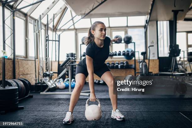 woman exercising with kettlebell - fitness vitality wellbeing photos et images de collection