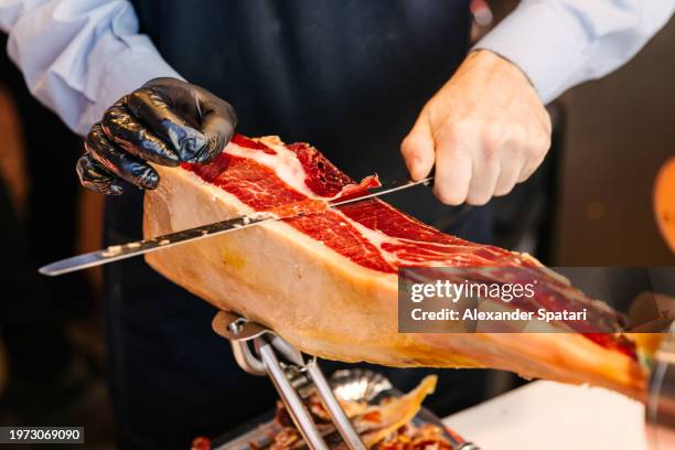 butcher slicing jamon serrano, close-up view - madrid tapas stock pictures, royalty-free photos & images